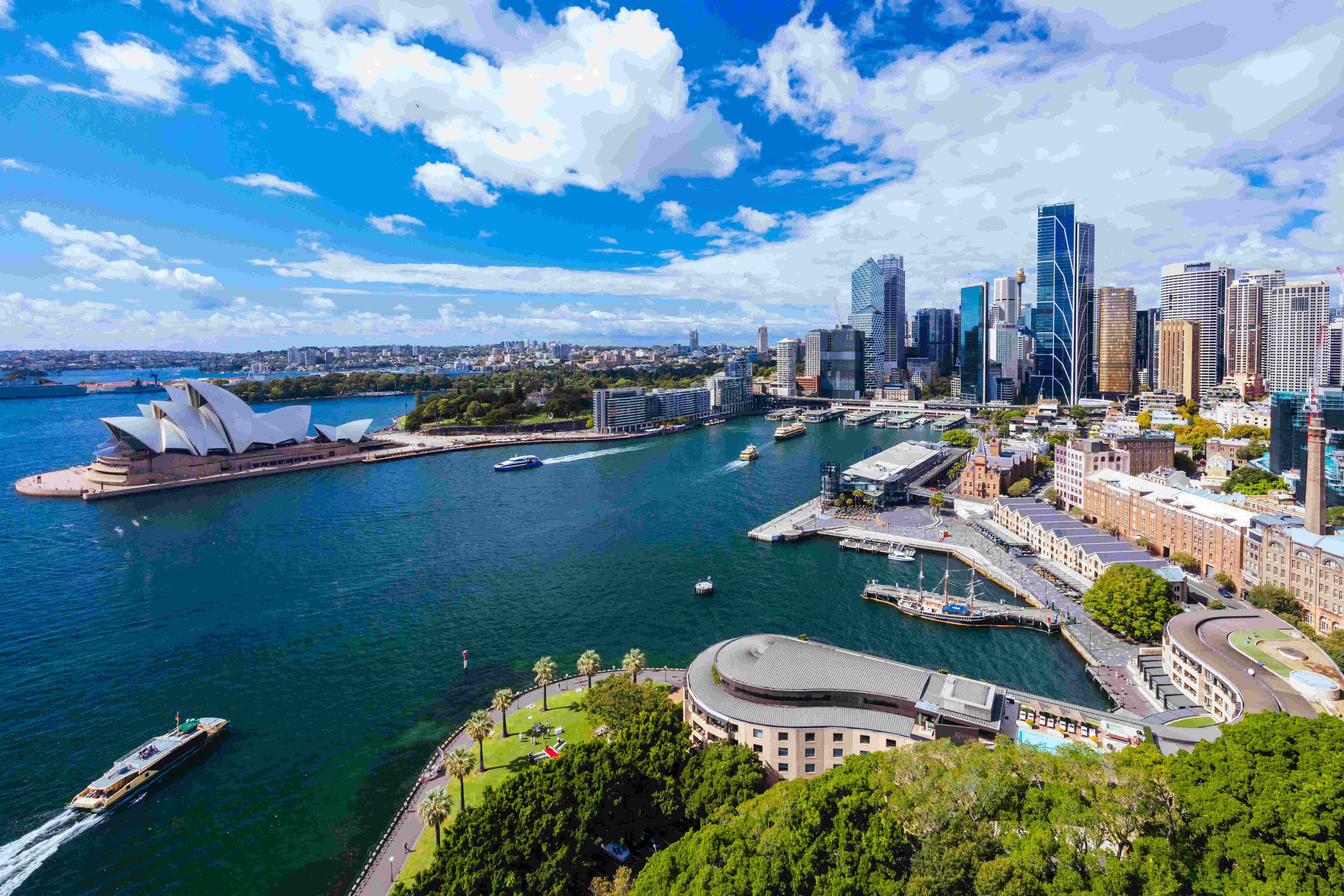 SYDNEY, AUSTRALIA - MARCH 4 2023: The Sydney CBD and surrounding harbour, including Circular Quay and The Rocks on a clear autumn day in Sydney, Australia