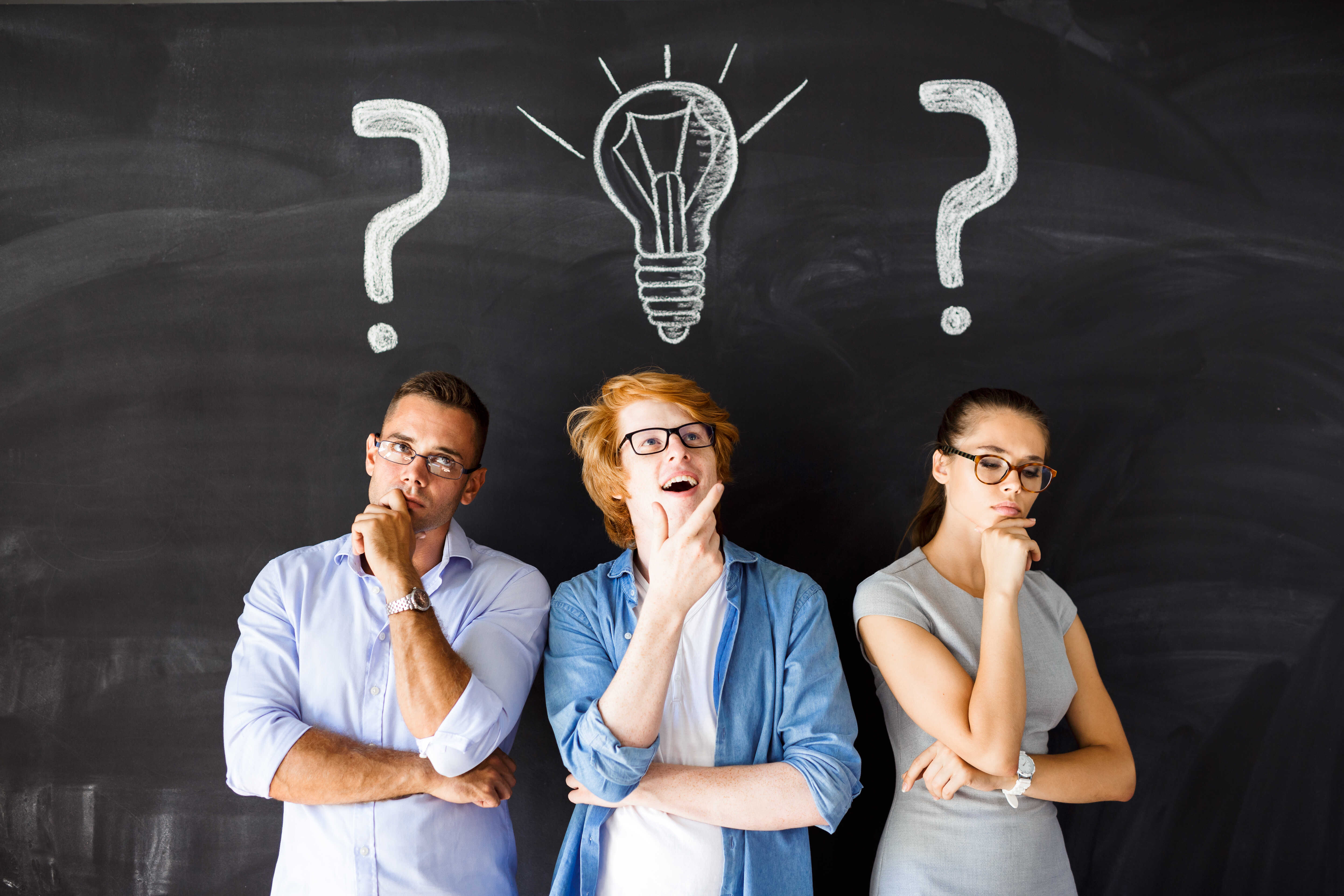 Creative guy with genuine idea surrounded by two pensive people